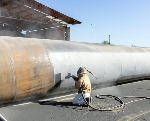 Abrasive blasting more commonly known as sandblasting is the operation of forcibly propelling a stream of abrasive material against a surface under high pressure.